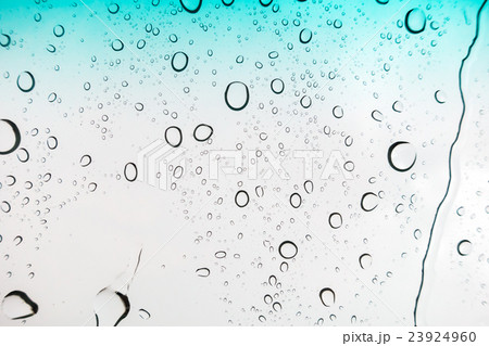 Water drops background. Water drops on glass window over blue sky 23924960
