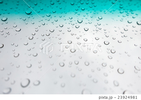 Water drops background. Water drops on glass window over blue sky Water drops background. Water drops on glass window over blue sky 23924981