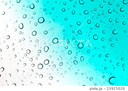 Water drops background. Water drops on glass window over blue sky Water drops background. Water drops on glass window over blue sky 23925020
