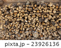 A pile of firewood at the wall of the wooden house 23926136