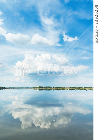 big cloud in blue sky and it reflection in river 23926208