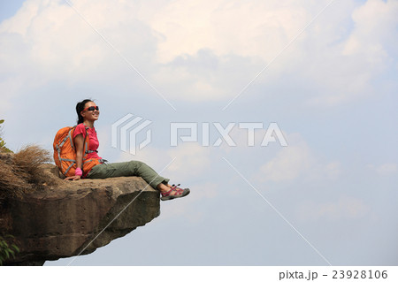 woman hiker enjoy the view at mountain cliff woman hiker enjoy the view at mountain cliff 23928106