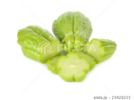 whole and sliced fresh chayote on white background 23928215