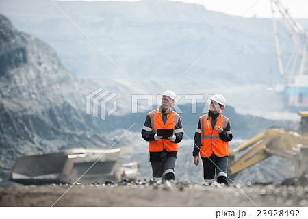 Workers with coal at open pit 23928492