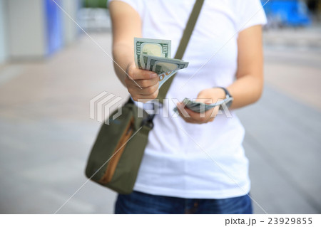 hands counting usd cash on street 23929855