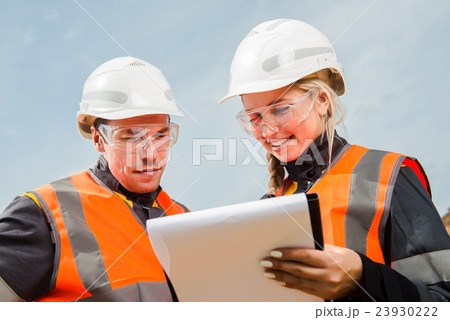 Two people working 23930222