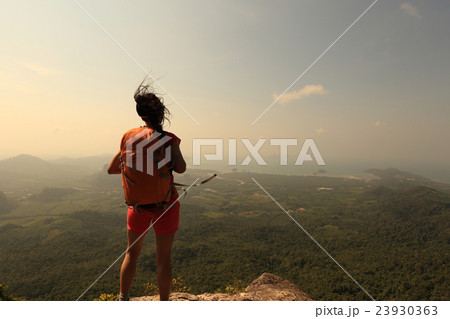 young woman hiker hiking on mountain peak cliff young woman hiker hiking on mountain peak cliff 23930363