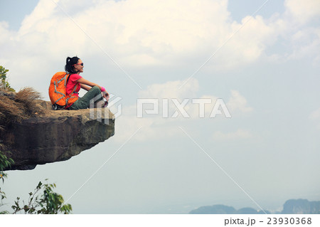 young woman hiker hiking on mountain peak cliff 23930368