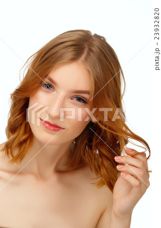 Pretty young woman with blue eyes and red lips plays with hair. Pretty young woman with blue eyes and red lips plays with hair. 23932820