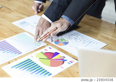 businessman analyzing with tablet and paperwork d 23934338