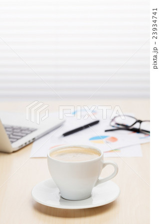 Office workplace with with laptop and coffee 23934741