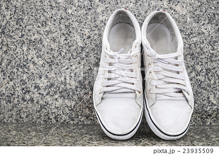 White sneakers on urban grunge background White sneakers on urban grunge background 23935509