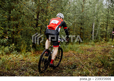 male athlete middle-aged rides in forest male athlete middle-aged rides in forest 23935666