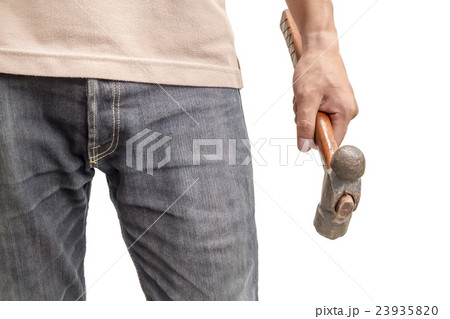 A young man's hand is holding old hammer 23935820