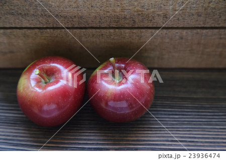 fresh red apples on a wooden background 23936474