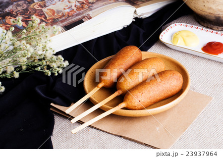 corndog with mustard, ketchup and parsley corndog with mustard, ketchup and parsley 23937964