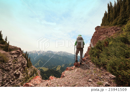 woman backpacke hiking on mountain peak cliff woman backpacke hiking on mountain peak cliff 23941509