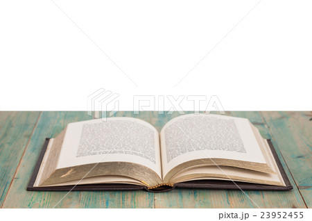 Open old book on wood 23952455