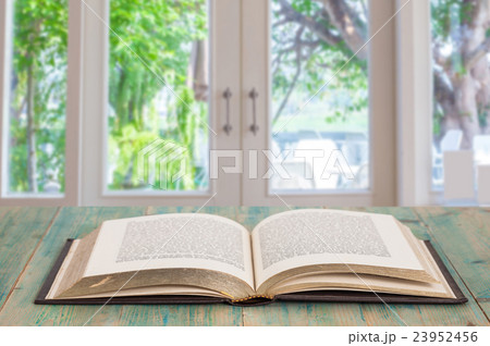 Open old book on wood Open old book on wood 23952456