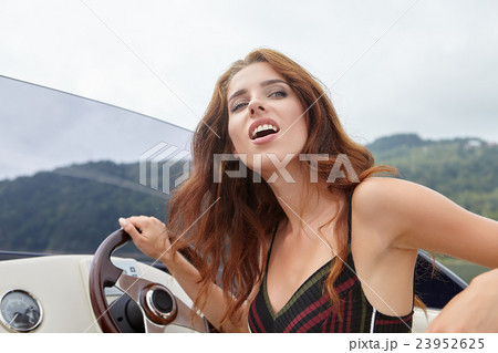 Summer vacation - young woman driving a motor boat Summer vacation - young woman driving a motor boat 23952625