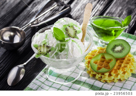 Ice Cream with kiwi fruit, Mint and waffles. 23956503