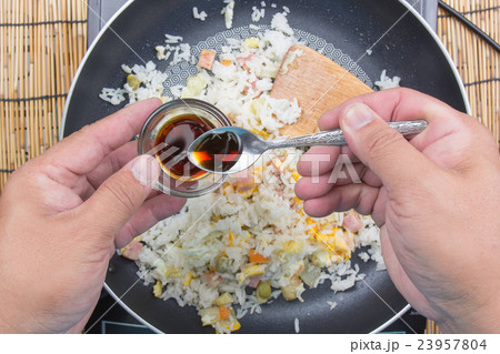 Chef putting soy sauce for cooking fried rice 23957804