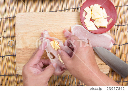 Chef putting cheese in pork Chef putting cheese in pork 23957842
