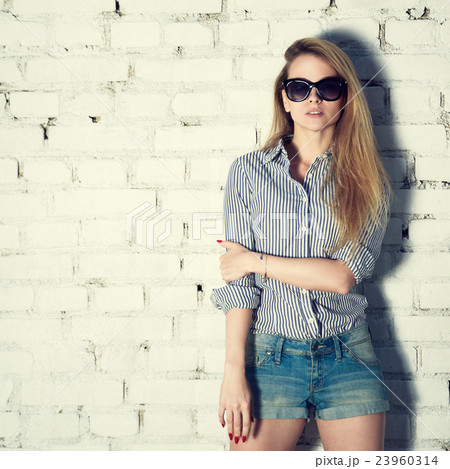 Street Style Fashion Girl at Brick Wall 23960314