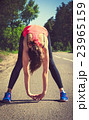 Young fitness woman runner stretching before run 23965159