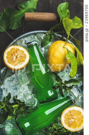 Bottles of green lemonade on chipped ice in metal 23969700