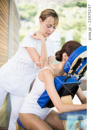 Female physiotherapist giving back massage 23970247