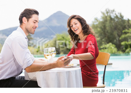 Couple looking at engagement ring 23970831