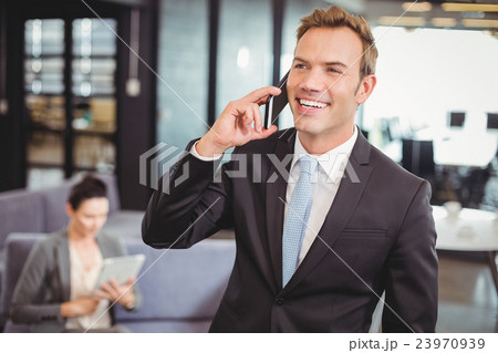 Businessman talking on mobile phone 23970939