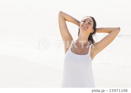 Beautiful woman stretching on the beach Beautiful woman stretching on the beach 23971106