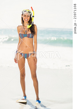 Young woman wearing flippers at the beach Young woman wearing flippers at the beach 23971108