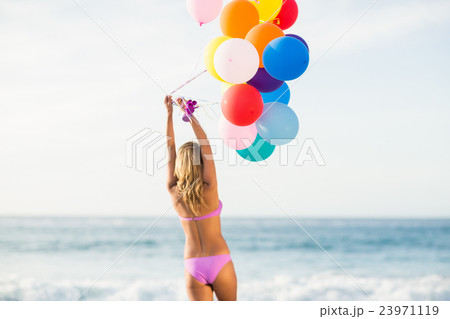 Beautiful woman holding balloon 23971119