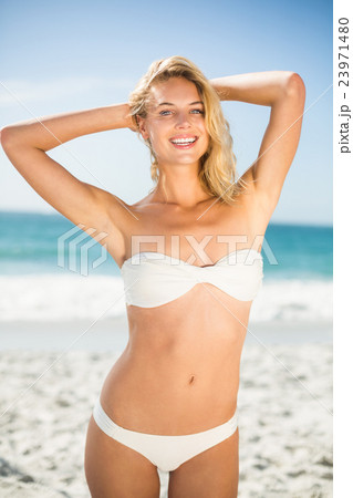 Smiling woman posing at the beach 23971480