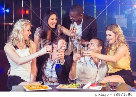 Friends with champagne and snacks Friends with champagne and snacks 23971596