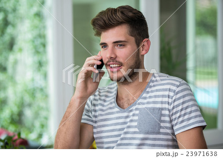 Smiling man talking on phone 23971638