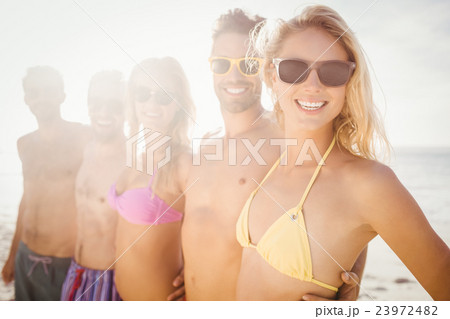 Smiling friends standing in line Smiling friends standing in line 23972482