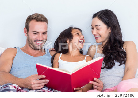 Happy family in their bedroom Happy family in their bedroom 23972486