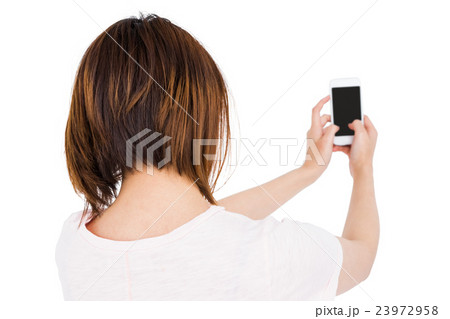 Woman using mobile phone Woman using mobile phone 23972958