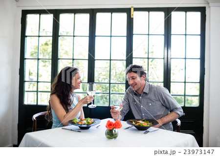Couple holding wine glass and interacting Couple holding wine glass and interacting 23973147