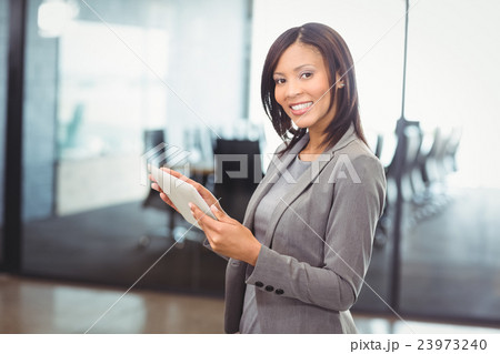 Attractive businesswoman holding digital tablet 23973240