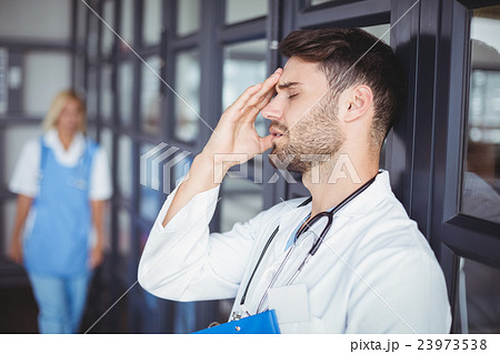 Close-up of male doctor suffering from headache Close-up of male doctor suffering from headache 23973538