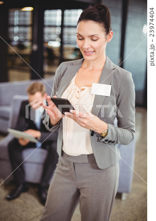 Businesswoman text messaging on mobile phone 23974404