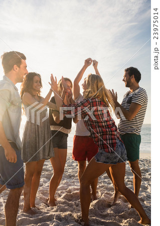 Happy friends dancing together 23975014