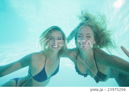 Beautiful young women underwater 23975206