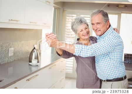 Portrait of cheerful senior man dancing with wife Portrait of cheerful senior man dancing with wife 23975328