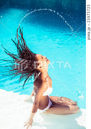 Beautiful woman tossing her wet hair Beautiful woman tossing her wet hair 23975725